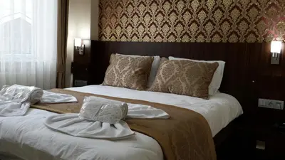 a hotel room with a bed with towels on it at Istanbul Central Hotel in Istanbul