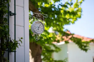 a clock hanging on the side of a building at No16 Ada in Adalar
