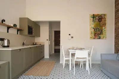 a kitchen and dining room with a table and chairs at Sunflower Apartments in Istanbul
