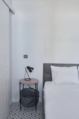a bedroom with a bed and a table next to a bed at Sunflower Apartments in Istanbul