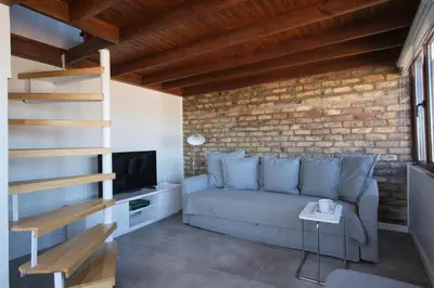 a living room with a couch and a brick wall at Sunflower Apartments in Istanbul