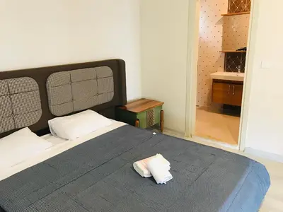 a bedroom with a large bed with a blue blanket at Sapanca Manzara Villa 2 Isıtma Havuzlu in Sapanca