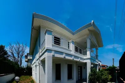 a large white house with a blue sky at Sapanca Manzara Villa 2 Isıtma Havuzlu in Sapanca