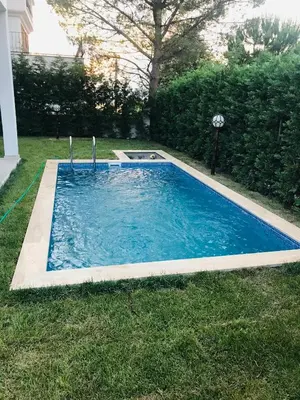 a small swimming pool in the grass with a yard at Sapanca Manzara Villa 2 Isıtma Havuzlu in Sapanca