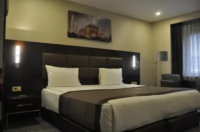 a hotel room with a large bed and a window at Happy Inn Gebze Hotel in Kocaeli