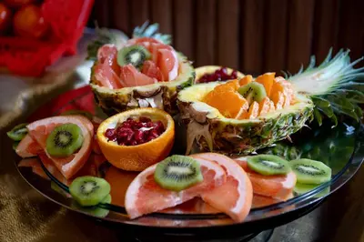 a plate filled with fruit on top of a table at Happy Inn Gebze Hotel in Kocaeli