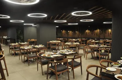 a dining room with tables and chairs in a restaurant at Happy Inn Gebze Hotel in Kocaeli