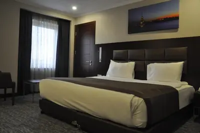 a bedroom with a large bed in a room at Happy Inn Gebze Hotel in Kocaeli