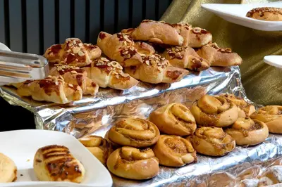 a bunch of pastries sitting on top of tin foil at Happy Inn Gebze Hotel in Kocaeli