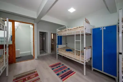 a room with two bunk beds and a hallway at XALİLA HOSTEL & CAFE LADİES ROOM in Istanbul