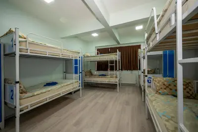 two bunk beds in a room with wooden floors at XALİLA HOSTEL & CAFE LADİES ROOM in Istanbul