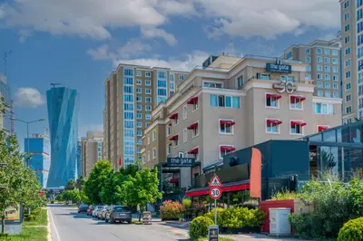 a building on a city street with buildings at The Gate Ataşehir Finance Centre in Istanbul