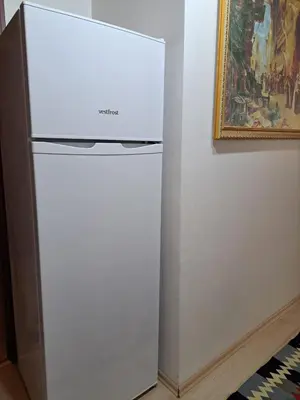 a white refrigerator in a room next to a painting at Golden Life GL in Istanbul