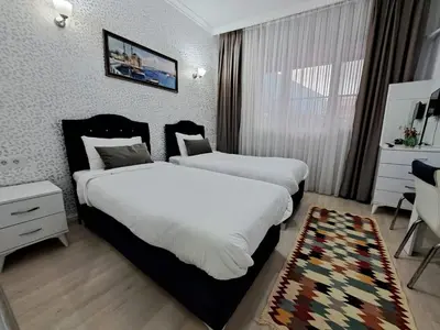 a hotel room with two beds and a mirror at Golden Life GL in Istanbul