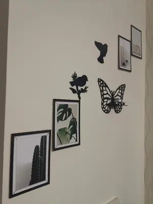 a group of butterflies and pictures on a wall at My G yoo Apartment #1 in Istanbul