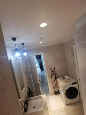 a bathroom with a sink and a washing machine at My G yoo Apartment #1 in Istanbul