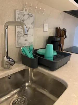 a kitchen sink with a tray with dishes in it at My G yoo Apartment #1 in Istanbul