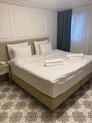 a large white bed with two white towels on it at İkiz Konak Boutique Hotel in Istanbul