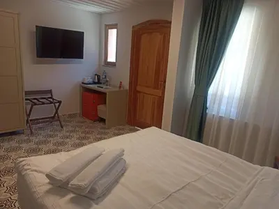 a bedroom with a bed with two towels on it at İkiz Konak Boutique Hotel in Istanbul
