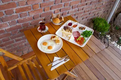 a table with two plates of breakfast food on it at İkiz Konak Boutique Hotel in Istanbul