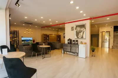 a lobby with tables and chairs in a building at Monezza Avcılar in Istanbul