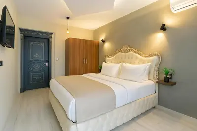 a bedroom with a white bed and a blue door at Monezza Avcılar in Istanbul