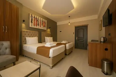 a hotel room with two beds and a couch at Monezza Avcılar in Istanbul