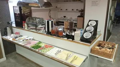 a display case in a restaurant with food on it at Nişantaşı Diamond Hotel in Istanbul