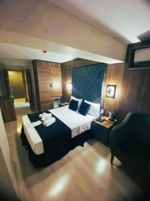 a hotel room with a bed and a chair at Nişantaşı Diamond Hotel in Istanbul
