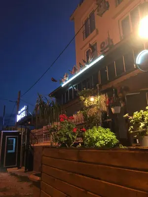 a building with flowers in front of it at night at Silver Continent Hostel in Silivri