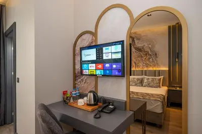 a hotel room with a desk and a mirror at World Class Hotel - Istanbul Airport in Arnavutköy