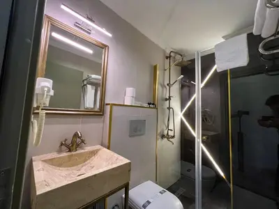 a bathroom with a sink and a shower and a toilet at By Kinyas Hotel in Istanbul