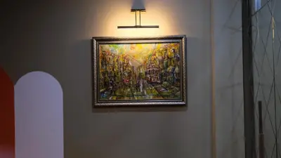 a painting hanging on a wall with a light at By Kinyas Hotel in Istanbul