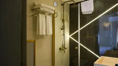 a bathroom with a shower with a glass door at By Kinyas Hotel in Istanbul