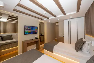 a bedroom with a bed and a tv on the wall at Hotel Grand İstanbul in Istanbul