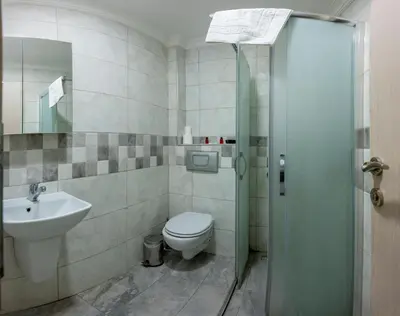 a bathroom with a toilet and a sink at Hotel Grand İstanbul in Istanbul