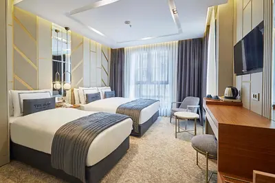 a hotel room with two beds and a television at THE HUBİ HOTEL in Istanbul