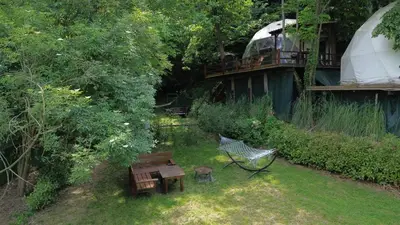 a garden with a table and a bench and a yurt at ME-GA Glamping in Sapanca