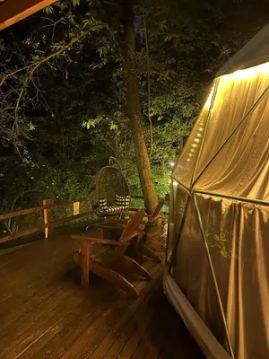a wooden deck with a bench and a tent at ME-GA Glamping in Sapanca