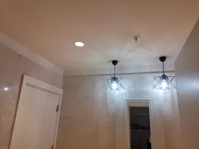 a bathroom with three lights hanging from the ceiling at My G yoo Apartment #2 in Istanbul