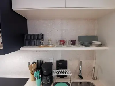 a kitchen with a sink and a counter with dishes at My G yoo Apartment #2 in Istanbul