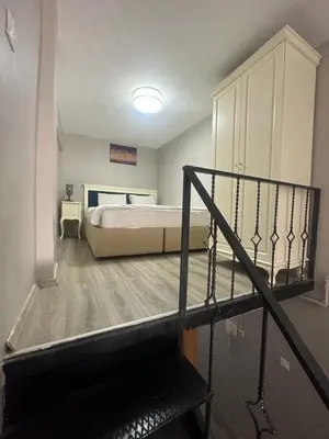 a bedroom with a bed and a staircase leading to a room at 1453Apartments in Istanbul
