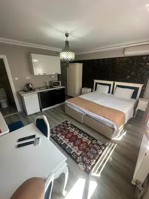 a bedroom with a large bed and a table at 1453Apartments in Istanbul