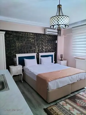 a bedroom with a large bed and a chandelier at 1453Apartments in Istanbul