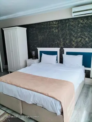 a bedroom with two beds and a wall at 1453Apartments in Istanbul