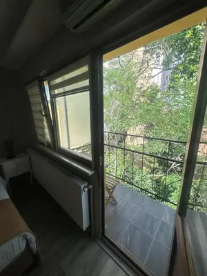 a room with two large windows and a balcony at 1453Apartments in Istanbul