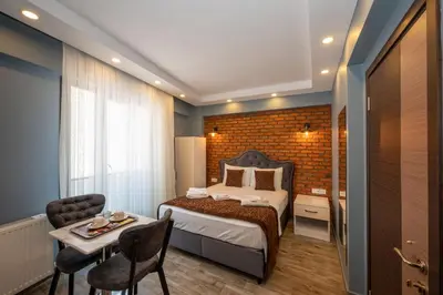 a bedroom with a bed and a table with a chair at Taksim Story Residence in Istanbul