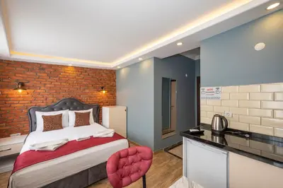 a bedroom with a bed and a brick wall at Taksim Story Residence in Istanbul
