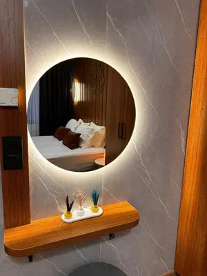 a mirror on a wall in a room with a bed at İstanbul Houses Sabiha Gökçen Airport in Istanbul