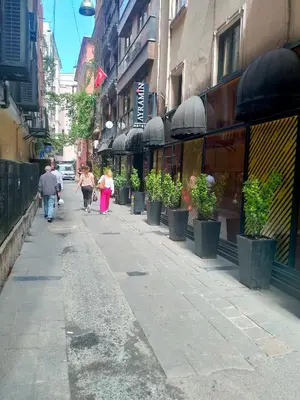 a group of people walking down a city street at 2 bedrooms central area located appartment 1floor in Istanbul